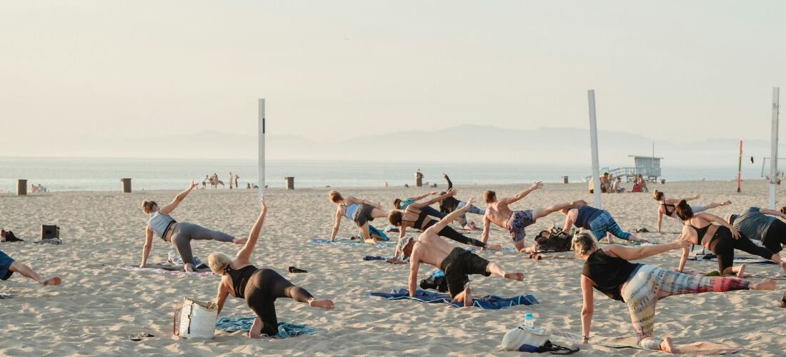 Vinyasa yoga class on the beach