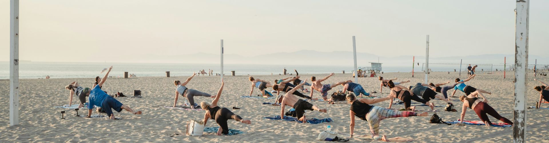 Vinyasa yoga class on the beach